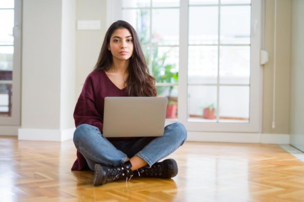 woman on her computer on online rehab