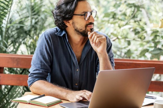 A man at a computer considers a drug rehab in florida and drug addiction treatment in tampa as he researches a drug rehab center in florida and a drug rehab in tampa