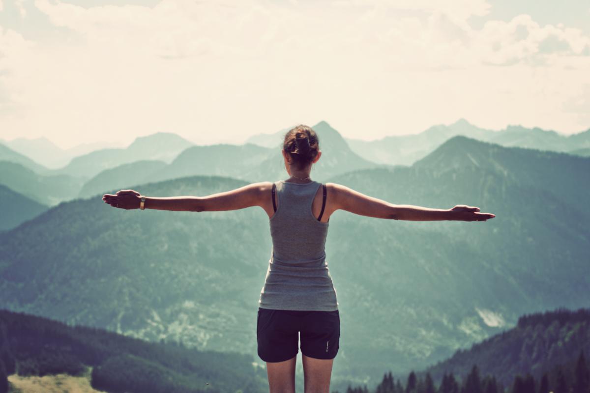 A woman at a drug detox program in florida considers attending a detox program in tampa and addiction detox in tampa as she stares at a mountain